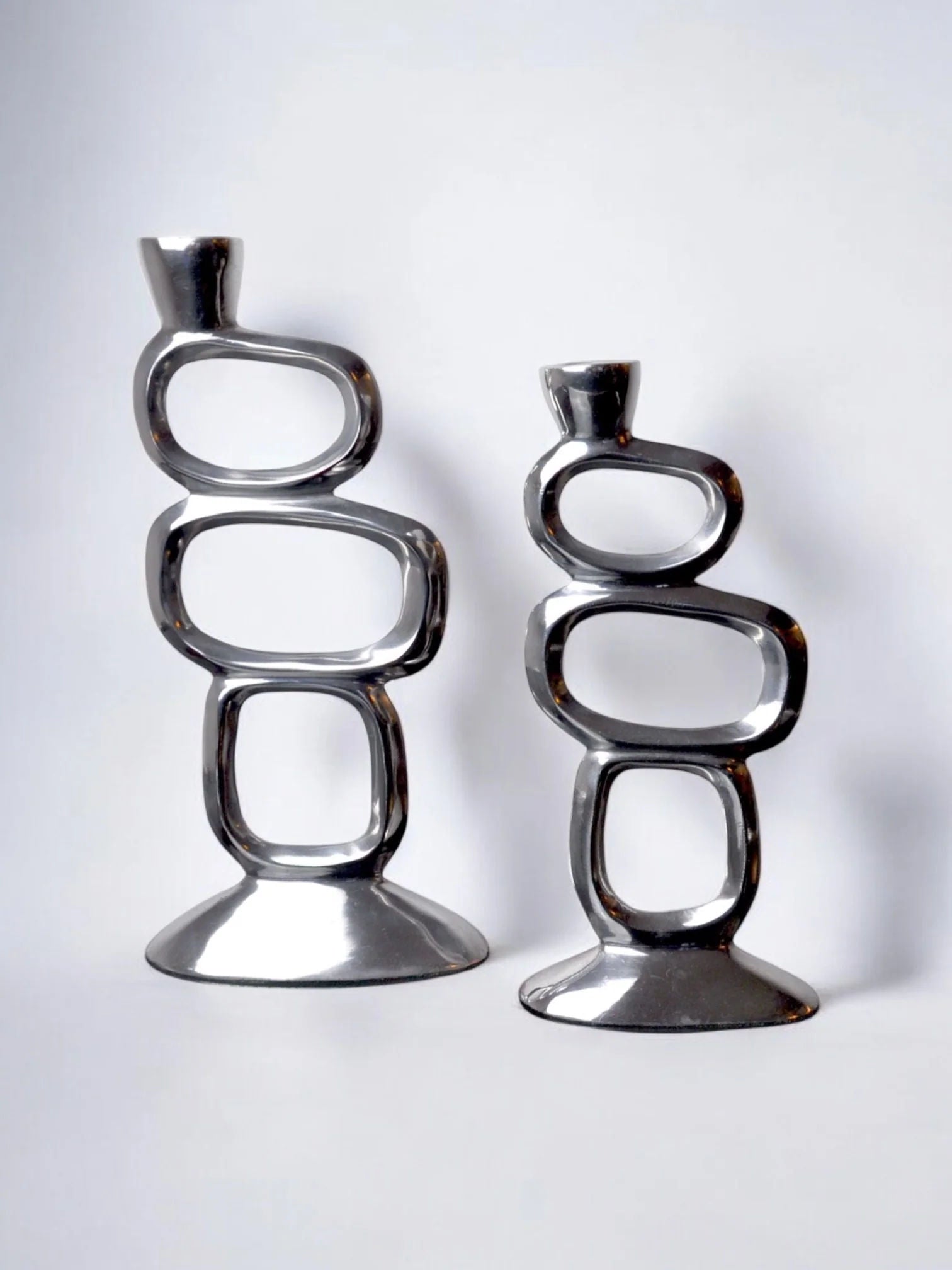 Pair of Candleholders by Matthew Hilton, 1980 — side angle showing polished metal finish