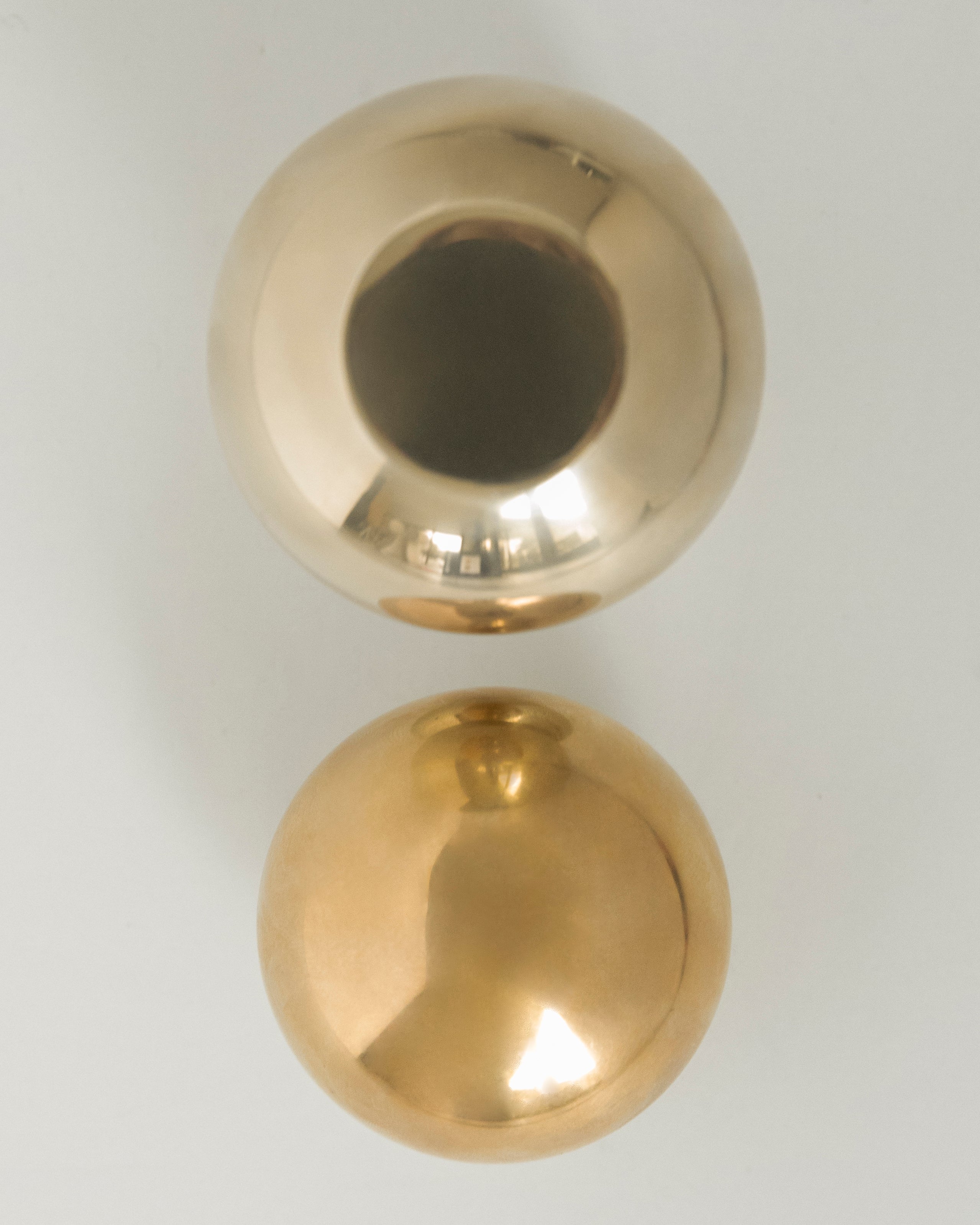 CERCLE Cabinet Knob Large — top view of polished brass knobs