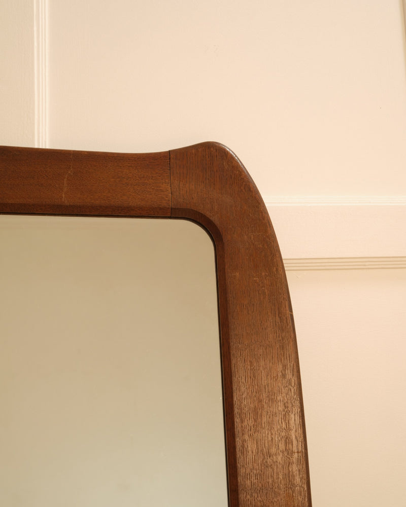Wooden organic mirror — close-up of curved wooden frame edge