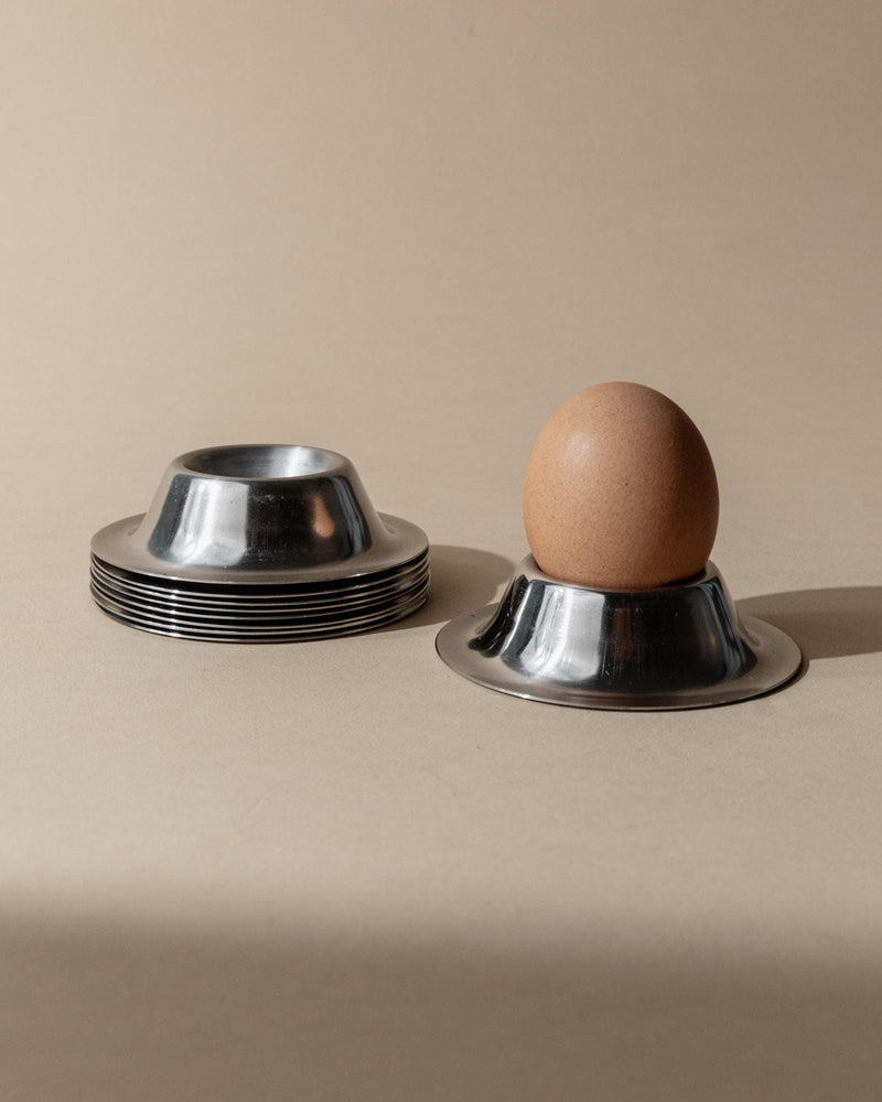 1970s Stainless Steel Egg Cups Set of 9 — close-up of egg cup with egg