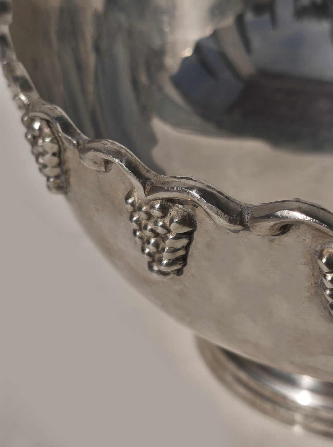 Silver decorative fruit bowl with ornate grape vine handle detail