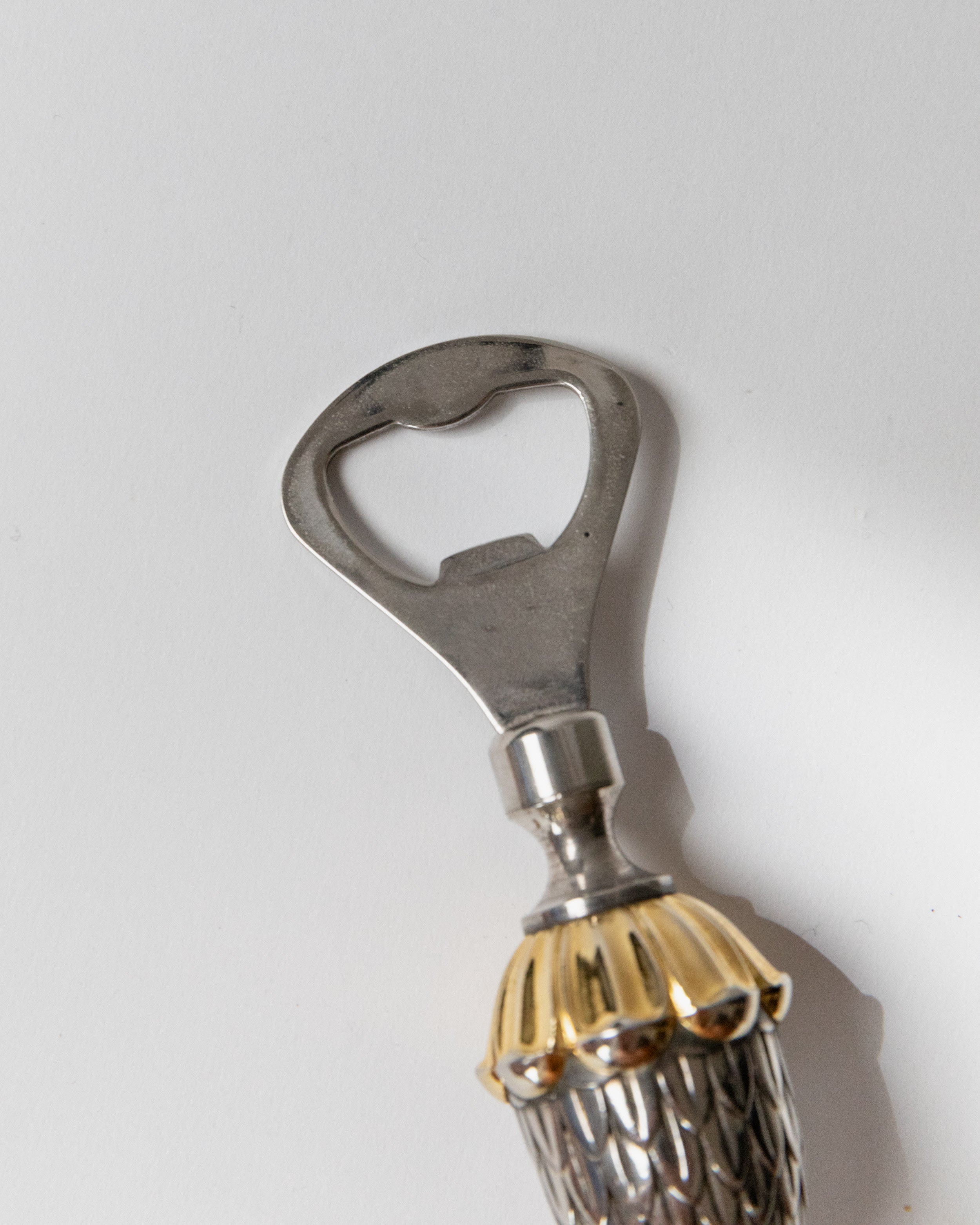 Silver-plated bottle opener detail showing ornate handle design