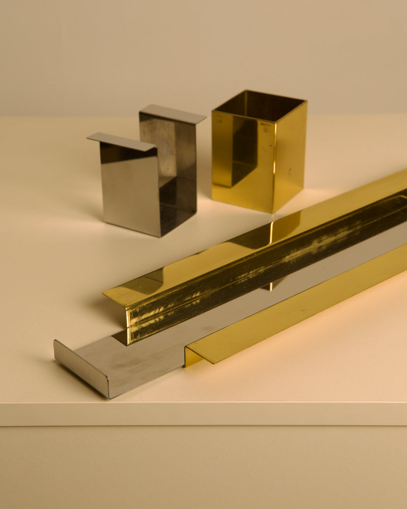 Close-up detail of gold and silver metal desk accessories set