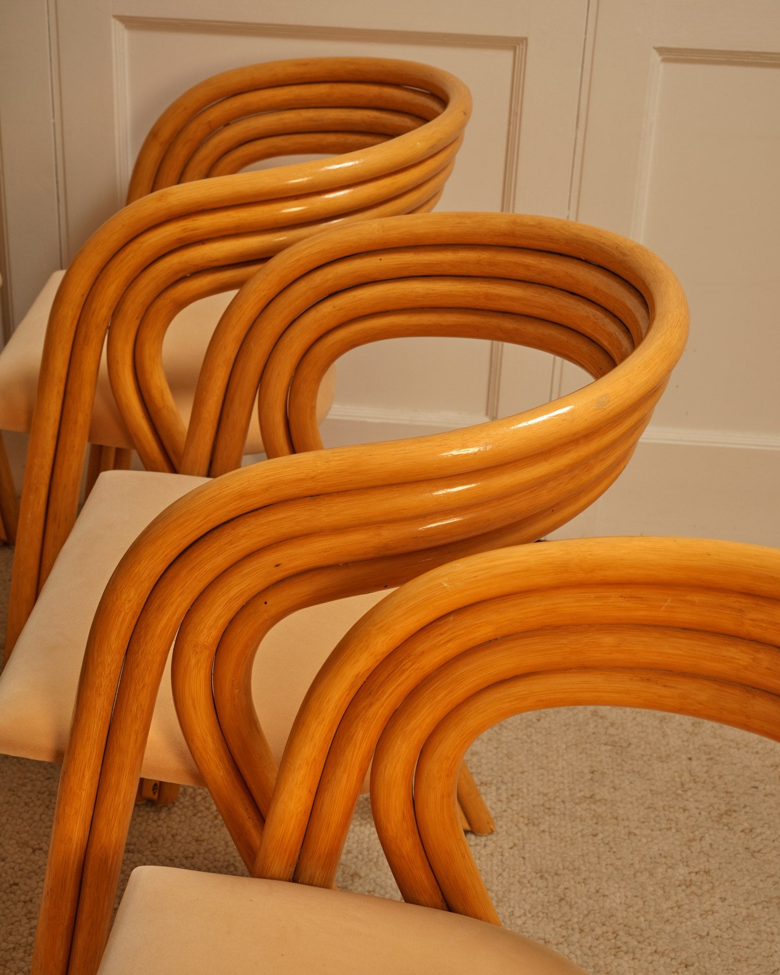 Stack of bent wood chairs showing curved backrest design detail