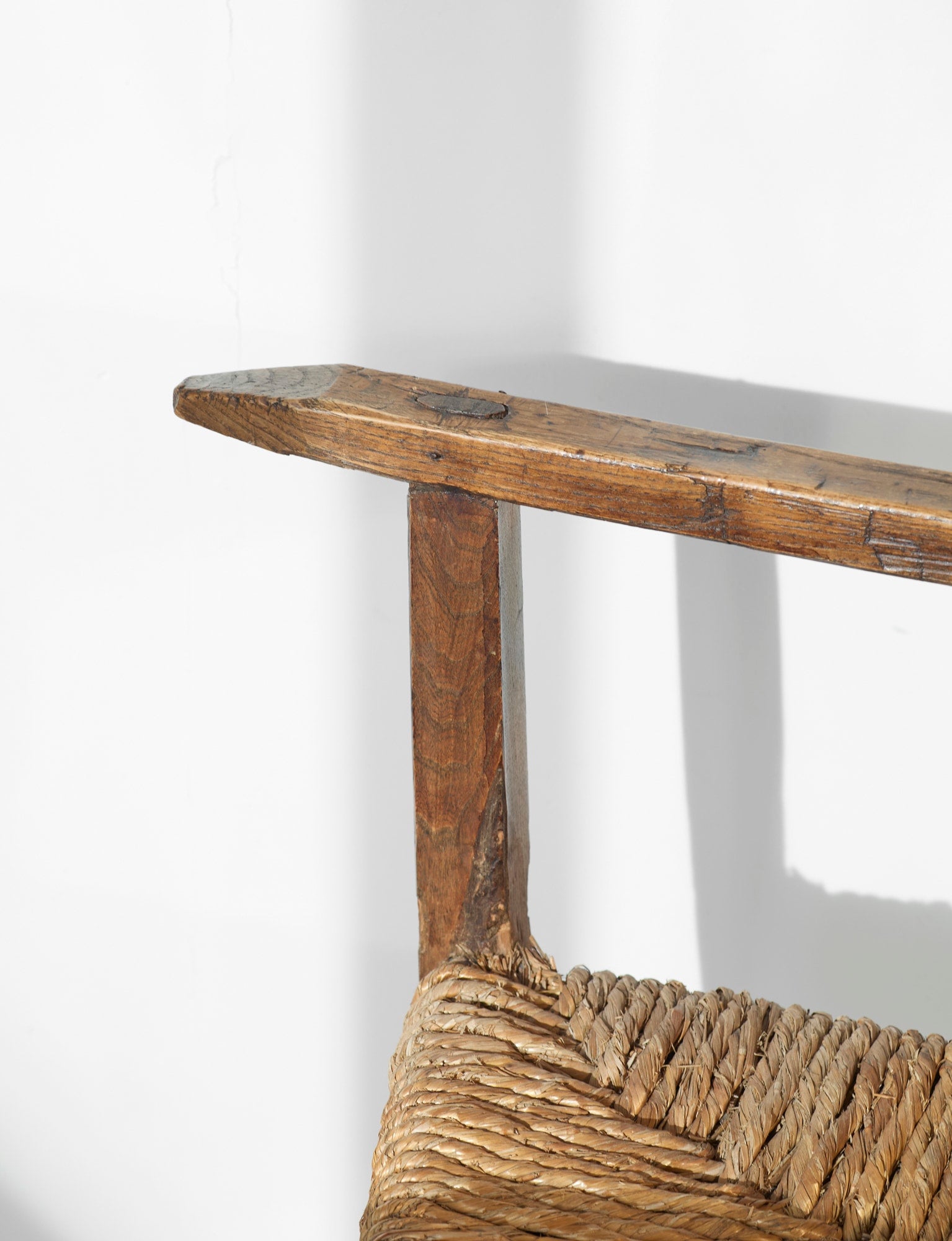 A French folk bench from the 19th Century. Wood and straw — lifestyle setting