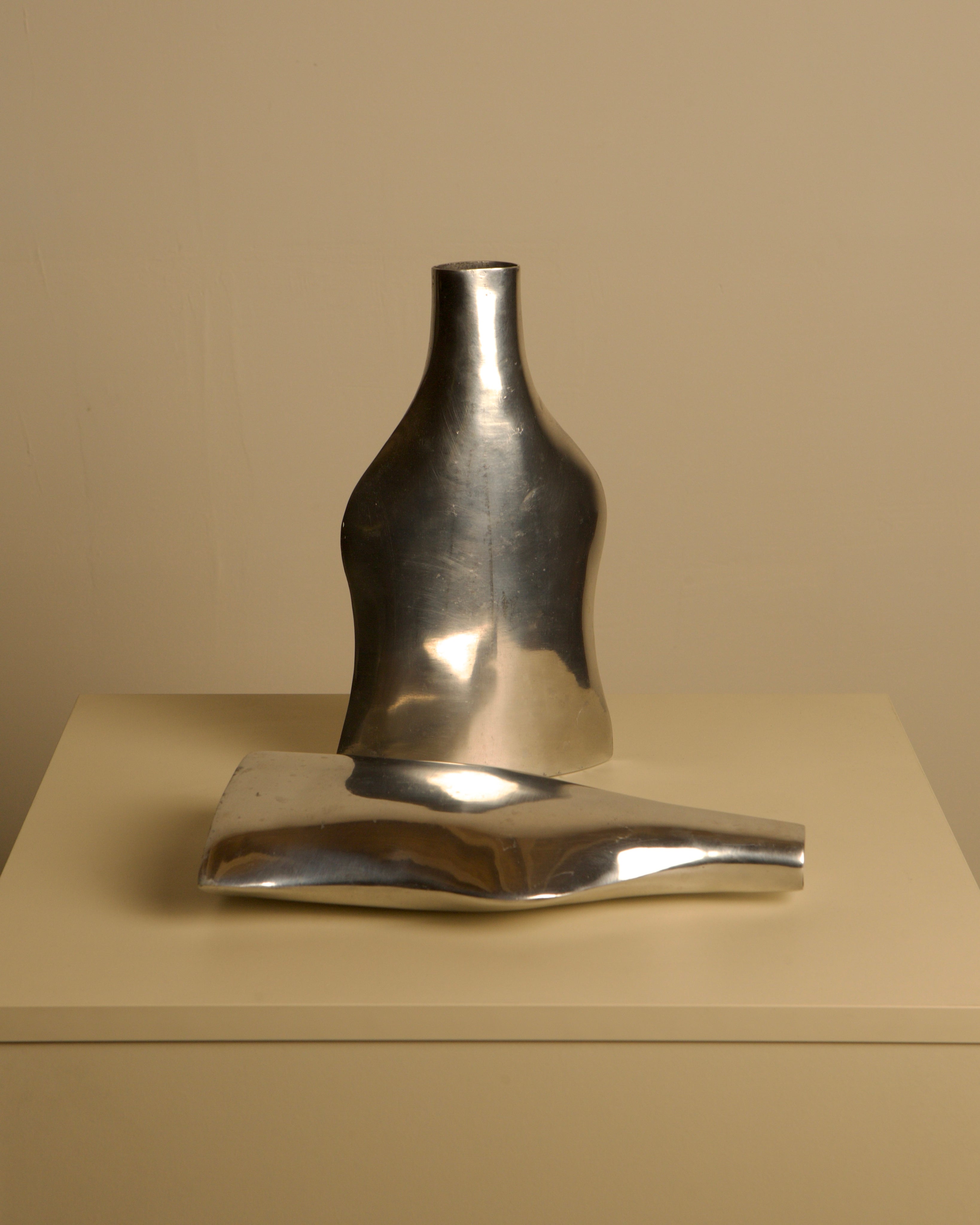 Pair of Italian Cast Aluminum Vases 1980s — angled view on neutral background