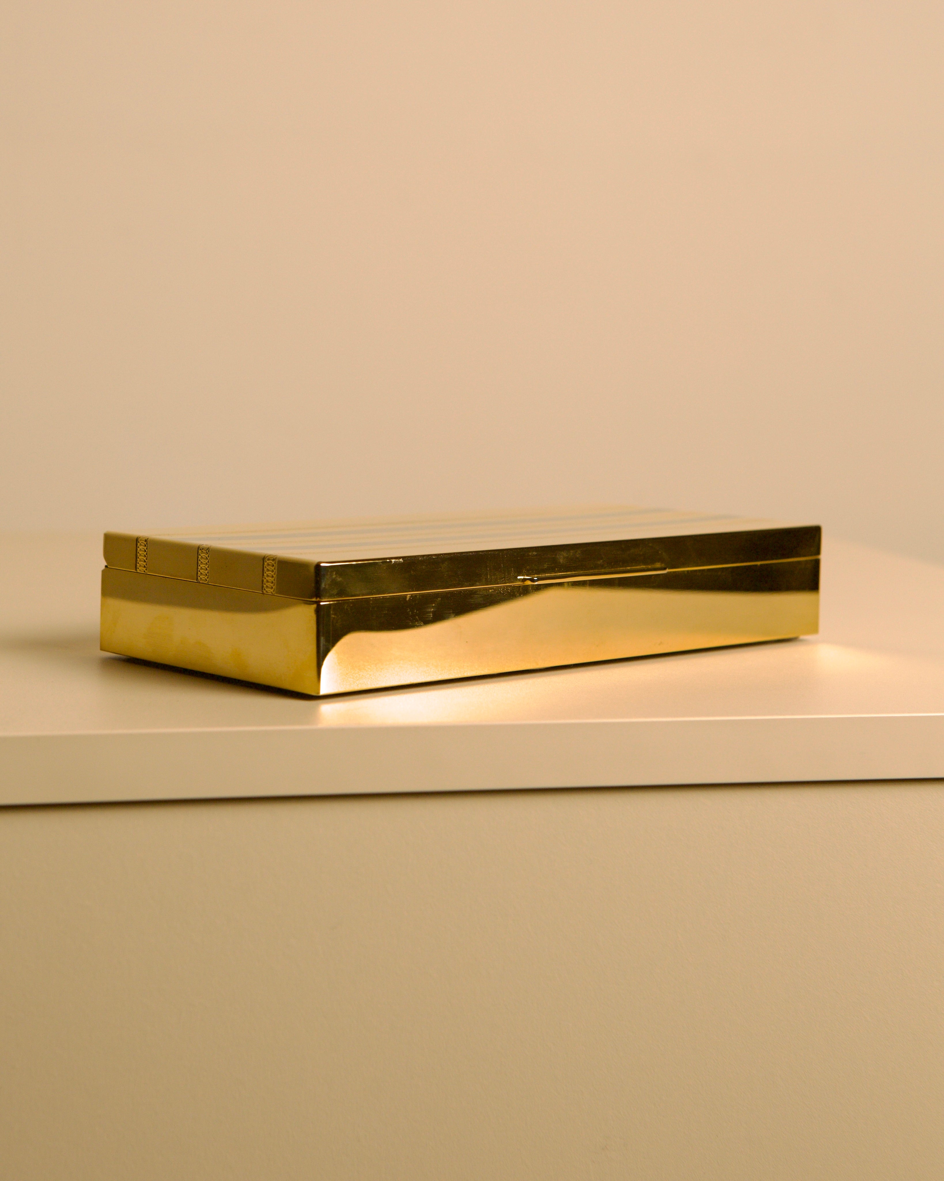 Italian Box in Gold and Silver Metal "Holywood Regency" 70s — angled view on minimalist shelf