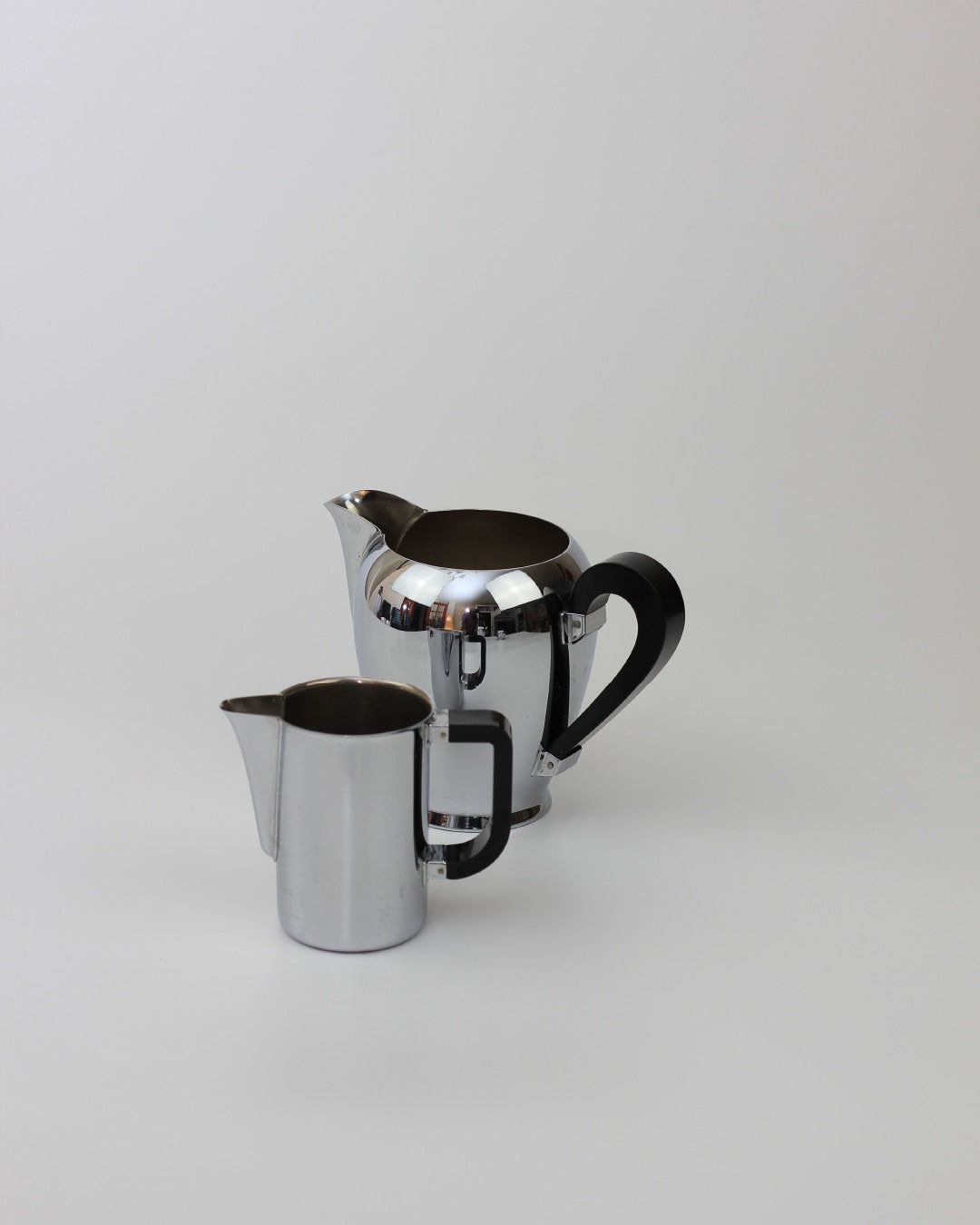 Italian Tea & Coffee Set — side angle of polished metal teapot and creamer