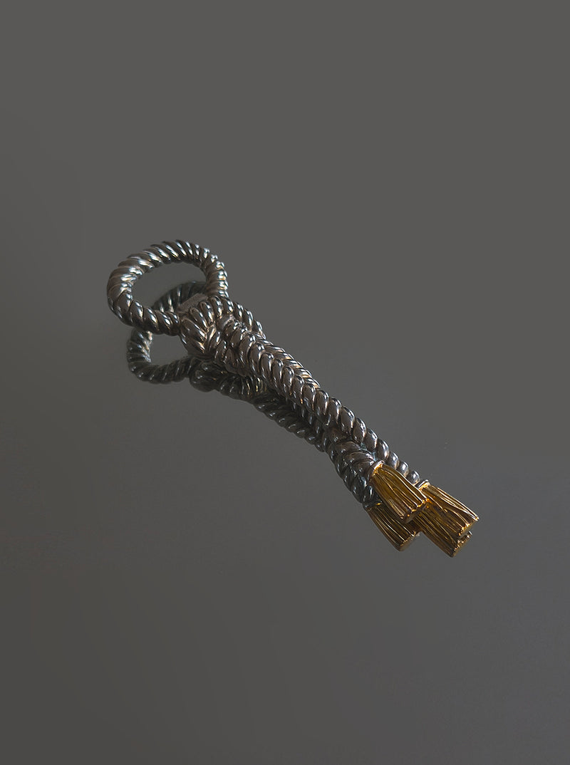 Rope Bottle Opener — close-up of twisted metal with gold accents