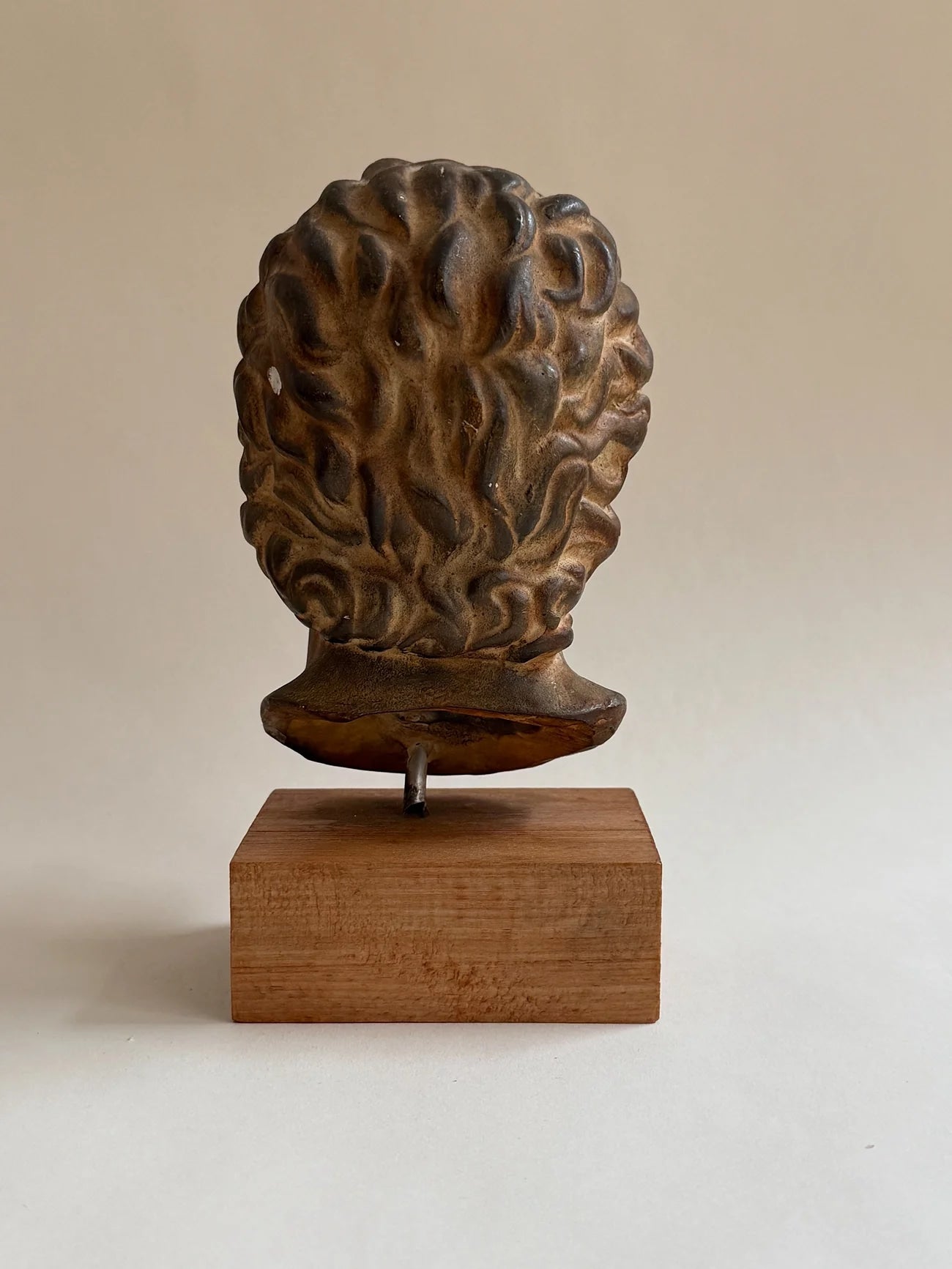 Sculptural Bust on Wooden Plinth — rear view highlighting textured surface