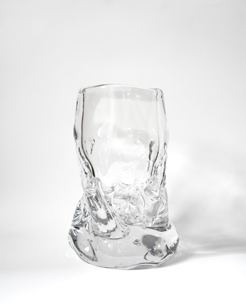 The Organically Shaped Hand-blown Vase No. 2 by Szkło Studio features an abstract, uneven design, highlighting the beauty of handcrafted glass art as it sits on a white surface against a plain white background.