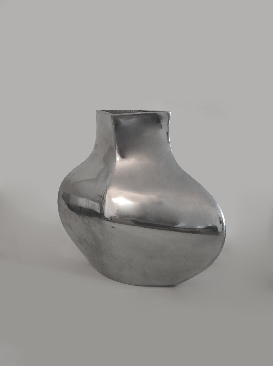 Sculptural Chrome Vase — close-up of reflective chrome surface
