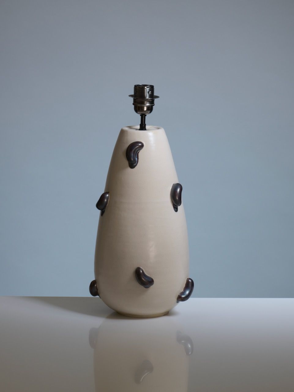 Contemporary Table Lamps in Ceramic - Oceano Collection — side angle of beige ceramic lamp with dark accents