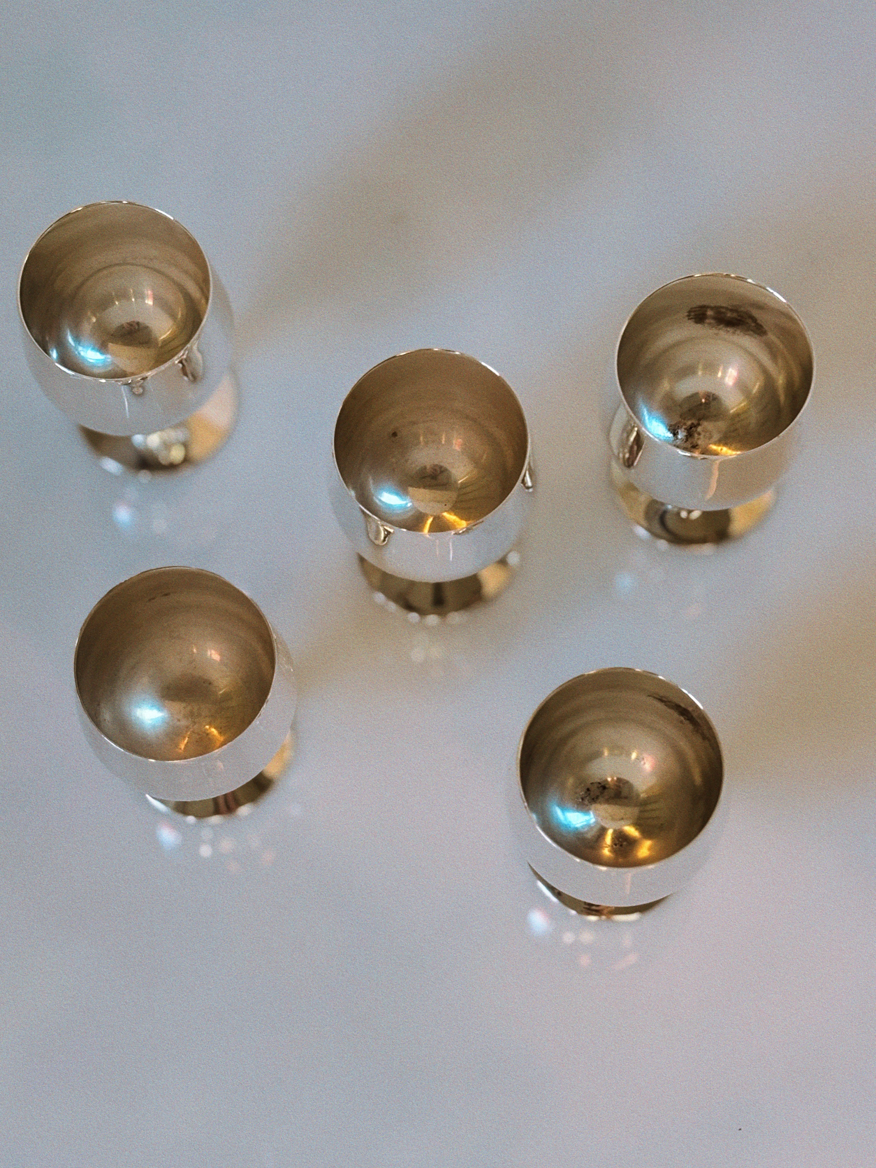 Set of 5 Silver Plated Liquor Cups, 70's Poland — top view on reflective surface