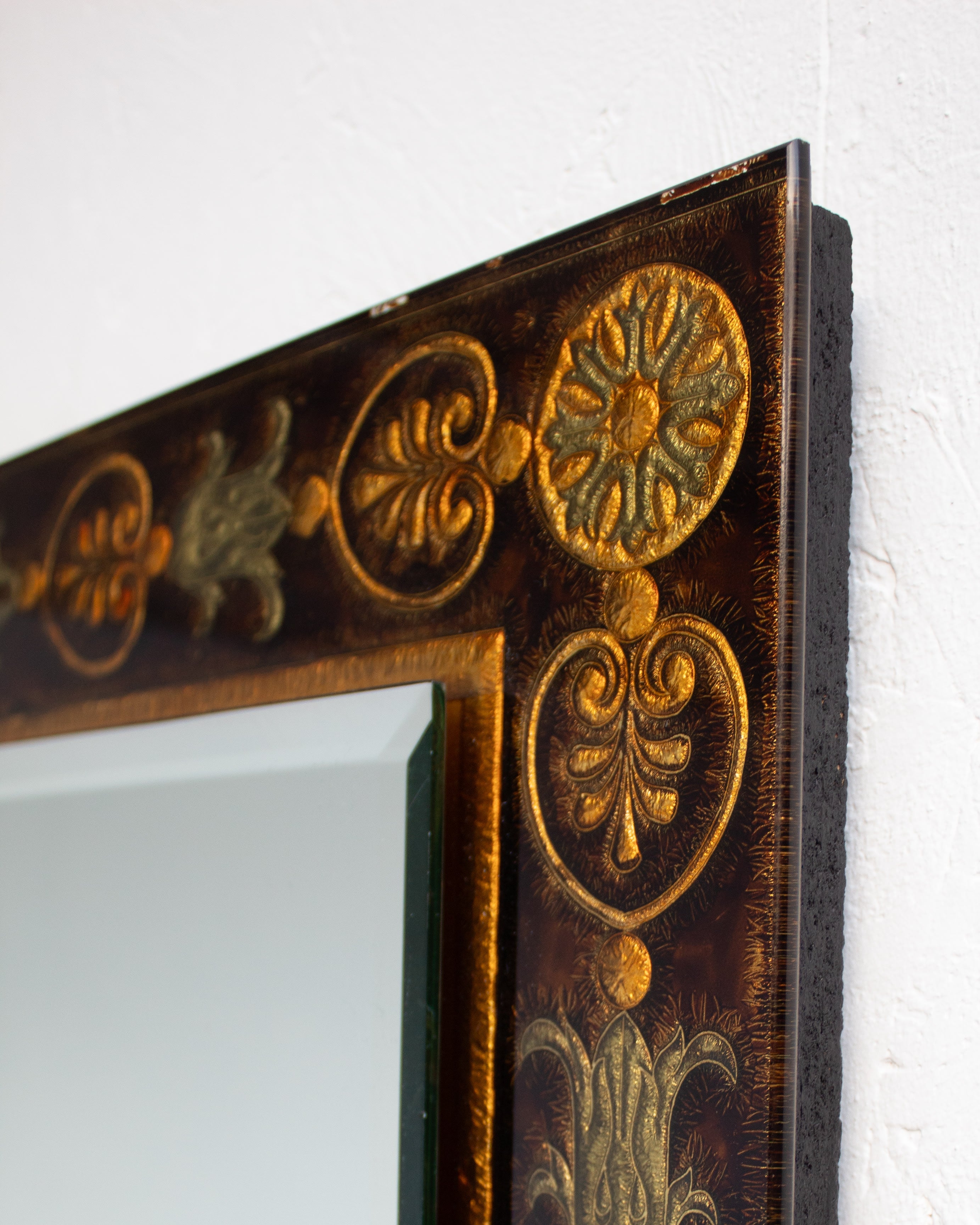 Ornate gilded frame corner detail showing decorative rosettes and scrollwork