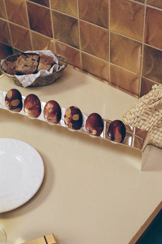 Minimalist Silver Tableware — top view with decorative eggs on countertop