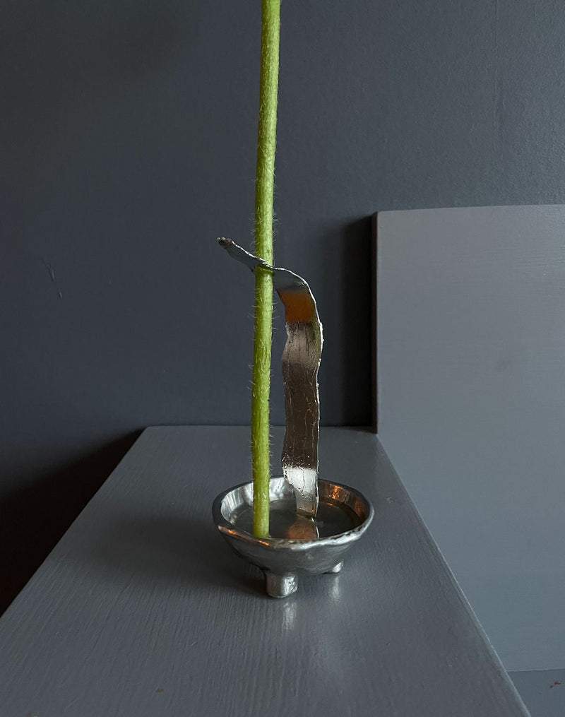 The Tin Collection / Favorite Vase — close-up of silver metal base with flower stem