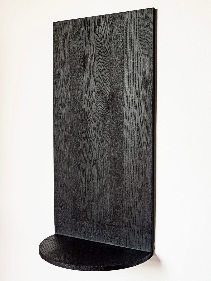 Black oak Megaron wall shelf with curved base from COSEINCORSO
