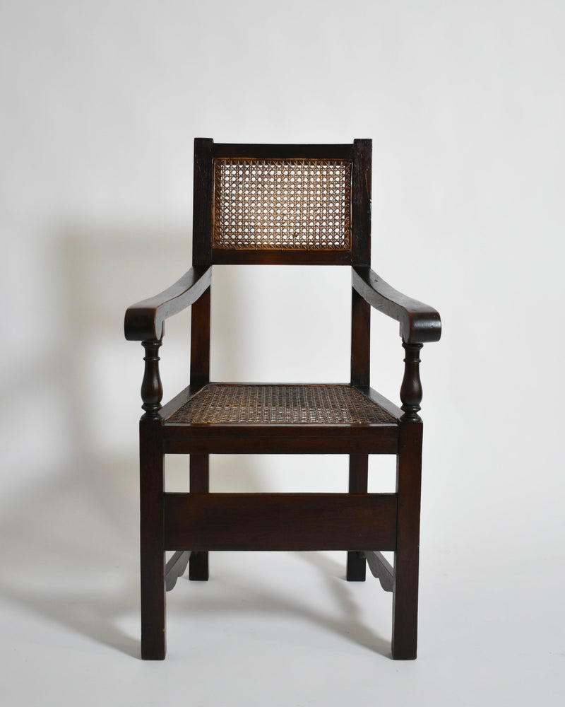 Pair of turned wood and cane armchairs, 1910s — front view highlighting cane seat and wooden frame