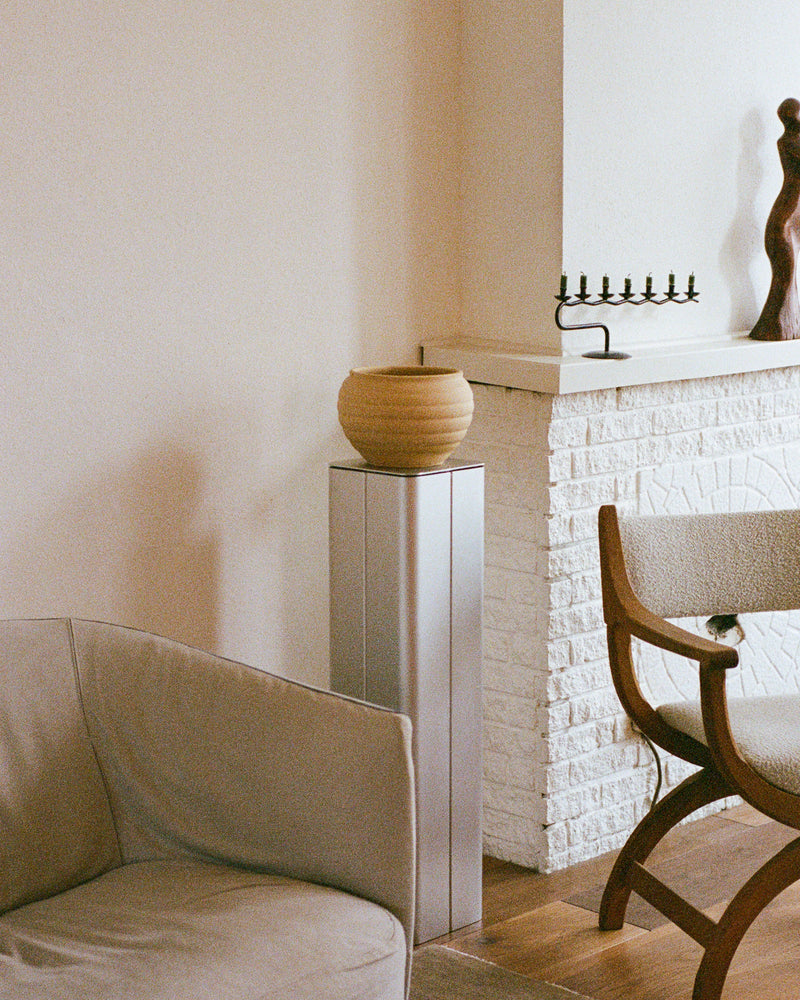 Gadroon aluminium side table styled in minimalist living room