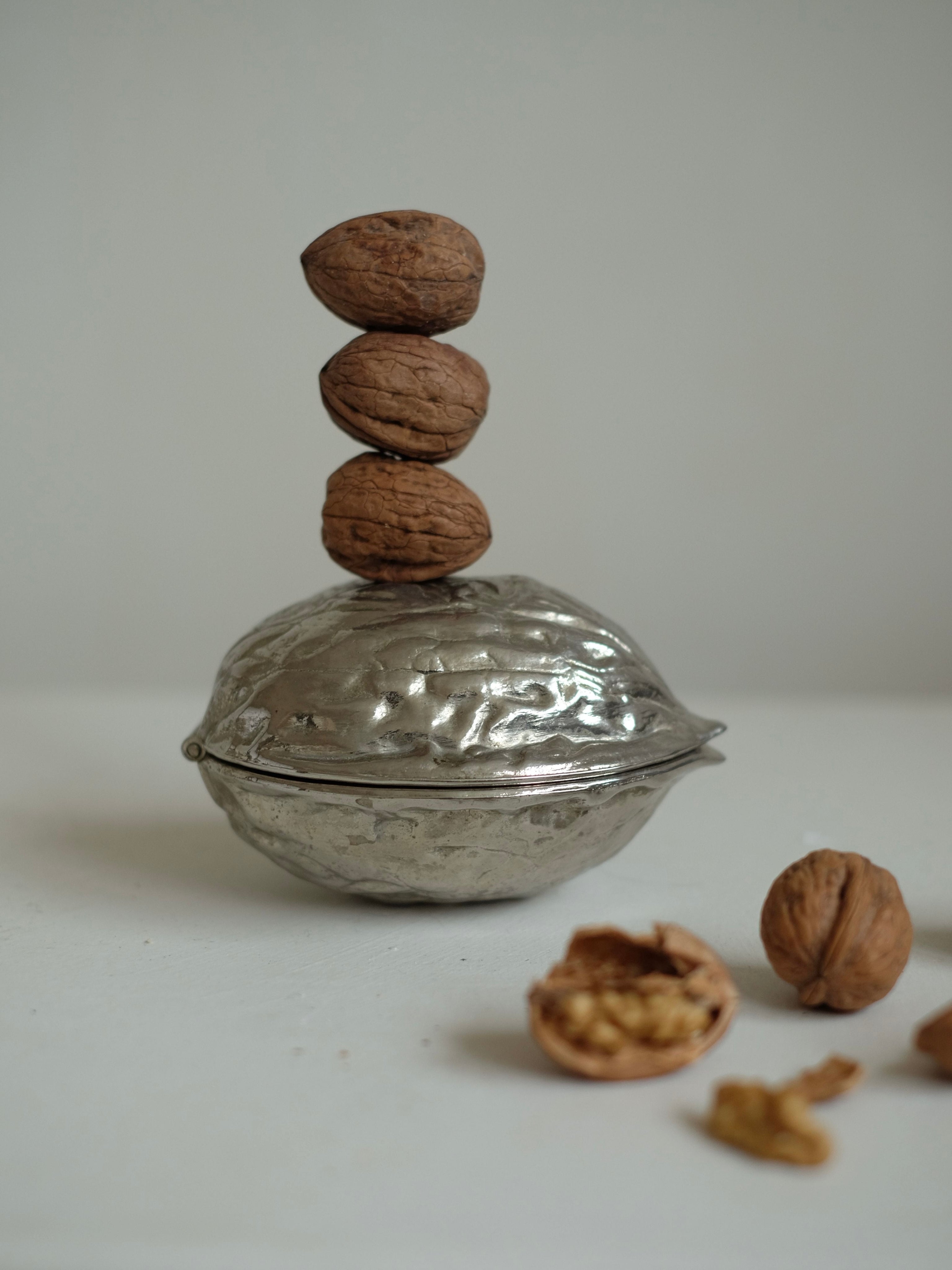 Nutcracker — back view of polished silver design with walnuts