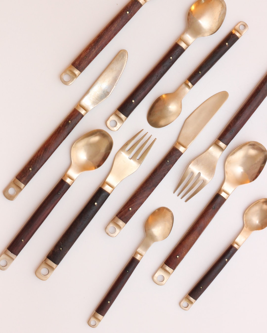 Cutlery Set — overhead view of brass and wood utensils