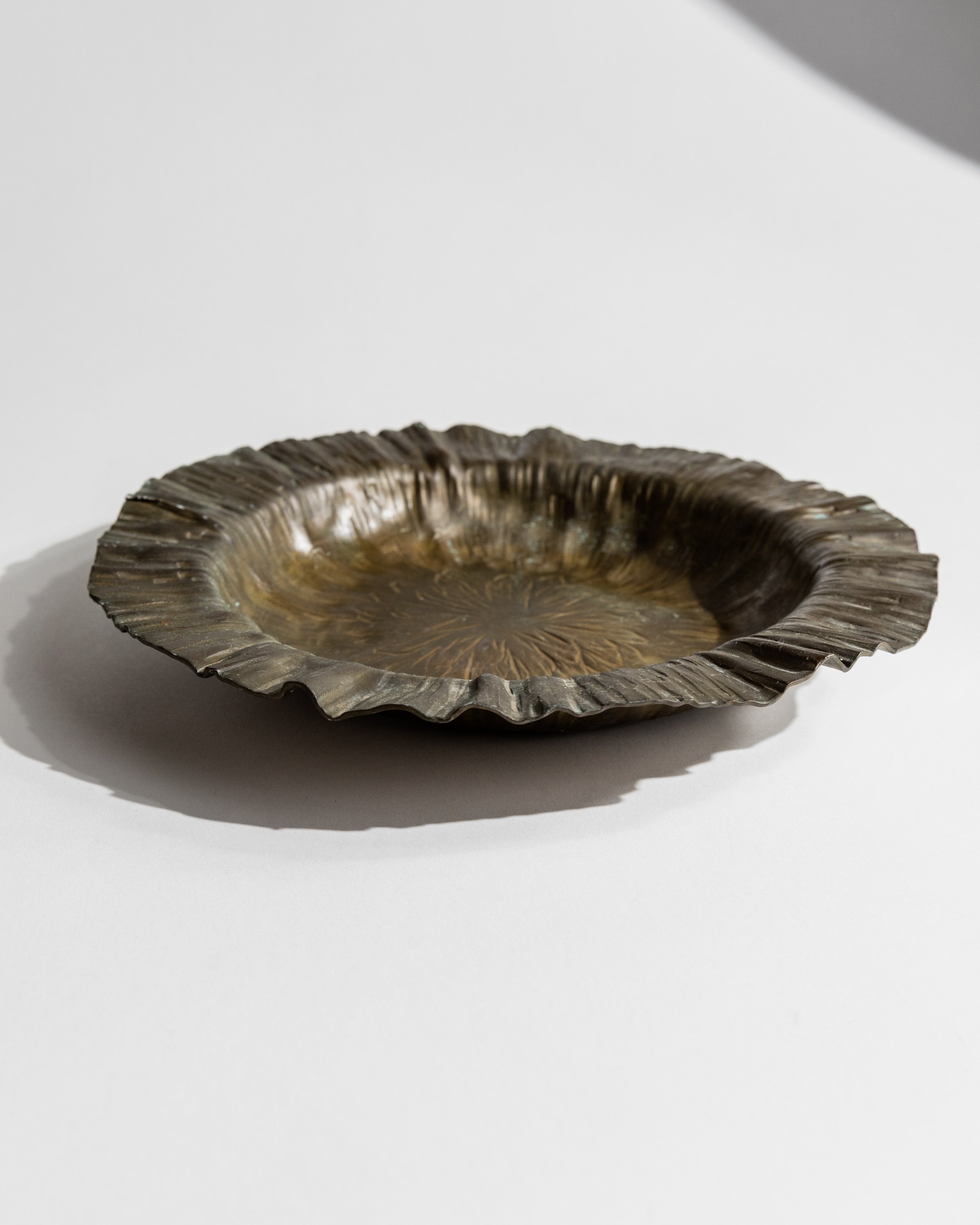 1960s brass scalloped bowl by Marioni on white surface