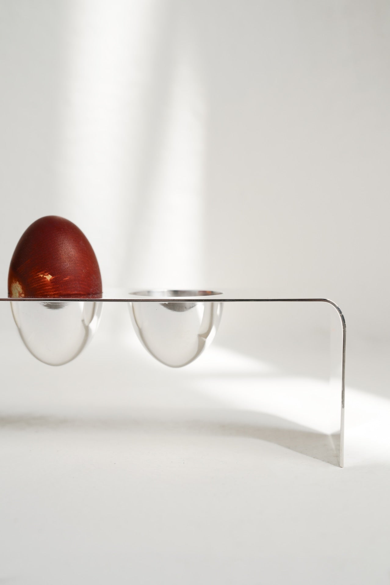 Minimalist Silver Tableware — side angle with red egg on stand