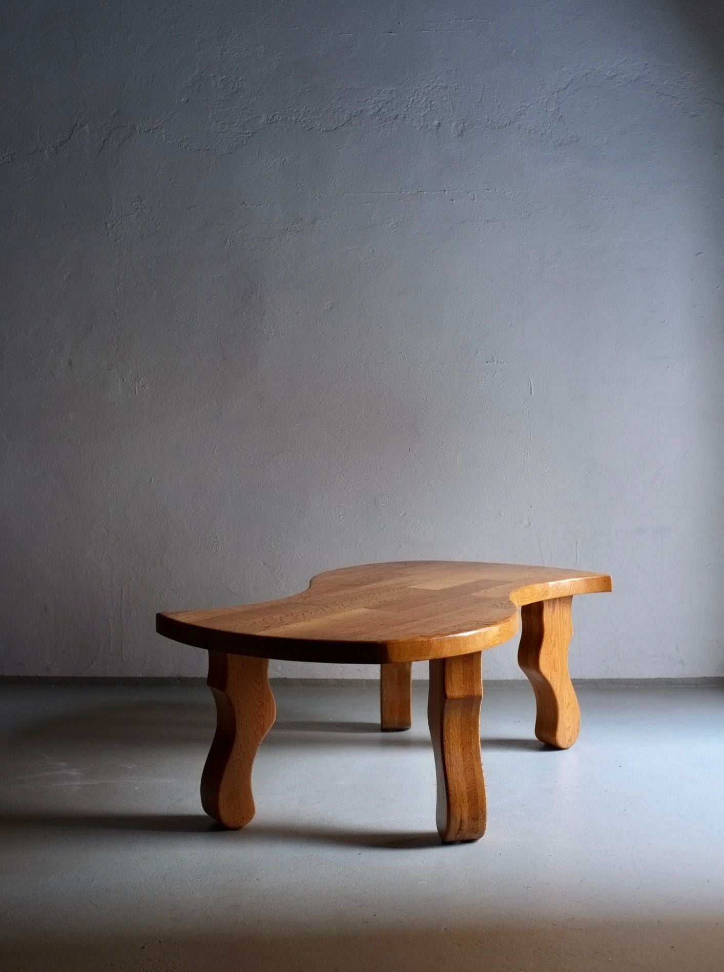 A close-up image of a unique and striking Brutalist sculptural oak coffee table, originating from the Netherlands in the 1970s