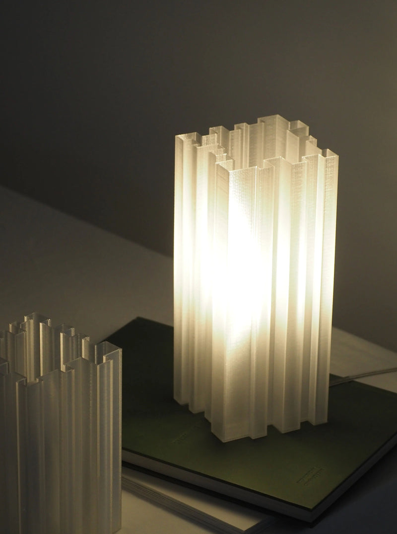 Orgue Lamp with silver base and white shade illuminating a modern living room
