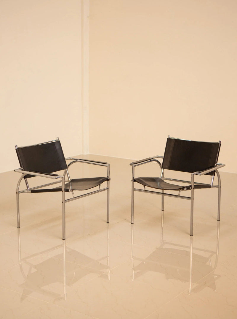 Pair of mid-century modern armchairs with wooden frames and velvet upholstery