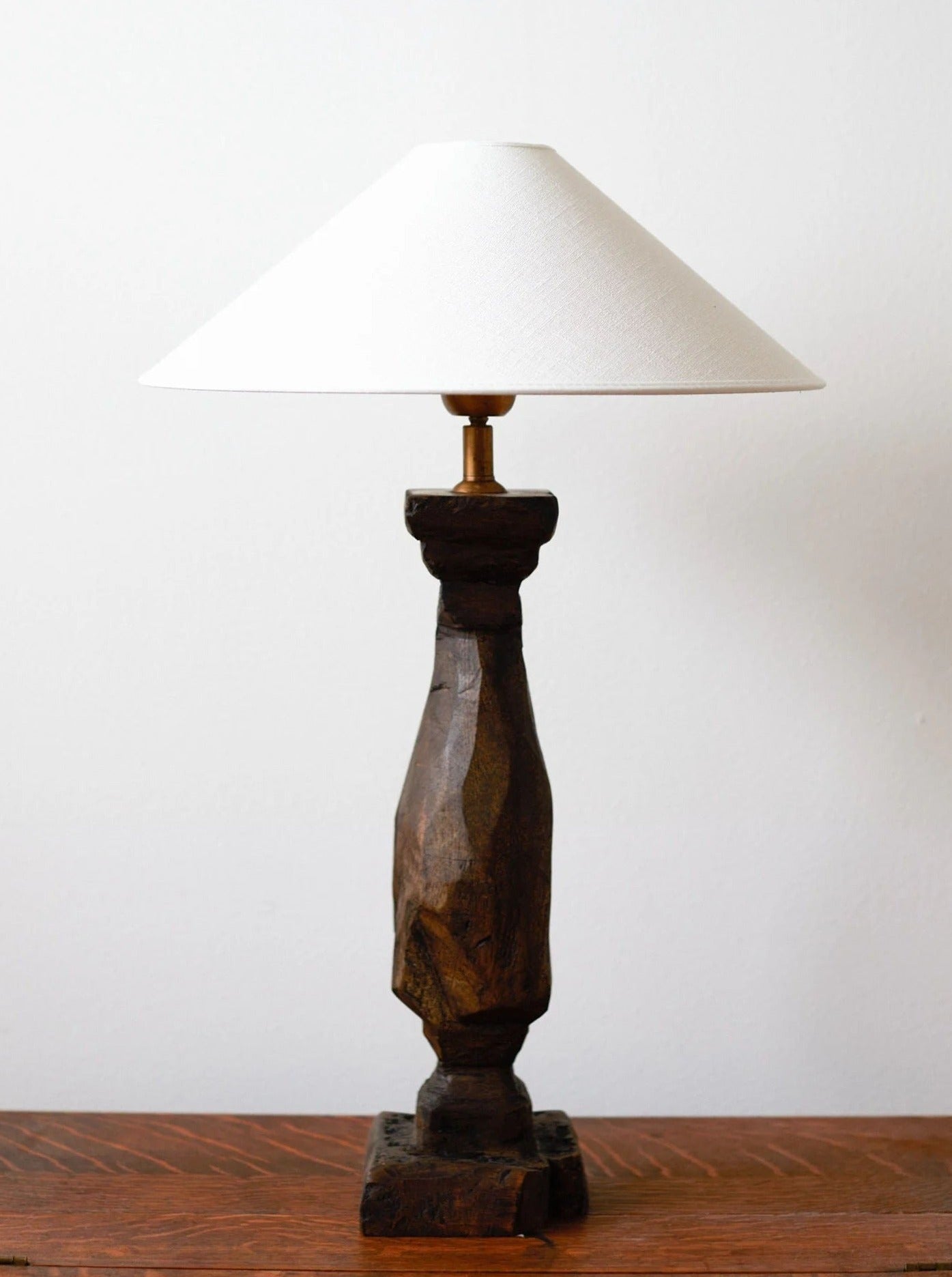 Handcarved wooden lamp with intricate floral design and warm light glow