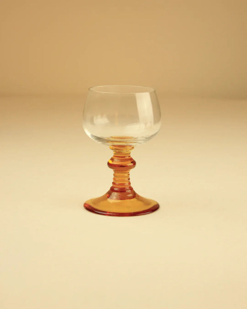  Close-up of two Roemer glasses showing intricate gold detailing on the stem and base 