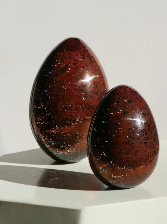 Bronze paperweight in the shape of a large egg, perfect for desk decor