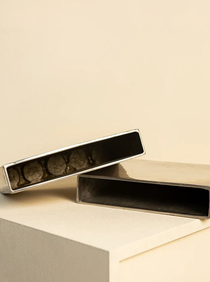 Set of two 1980s modernist Quintuor vases, featuring a unique blend of black and white marble swirls and a distinctive geometric shape