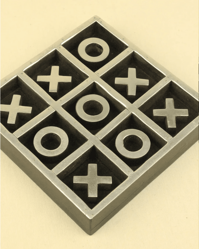 A sepia-toned photo of a Vintage Tic Tac Toe Game from Boga Avante Shop with x and o markers in a grid, showcasing a nearly completed game.