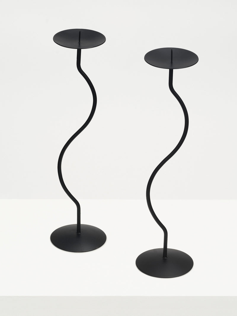 Two elegant iron sculptures of dancers, gracefully posed in a captivating dance routine, perfect for home decor