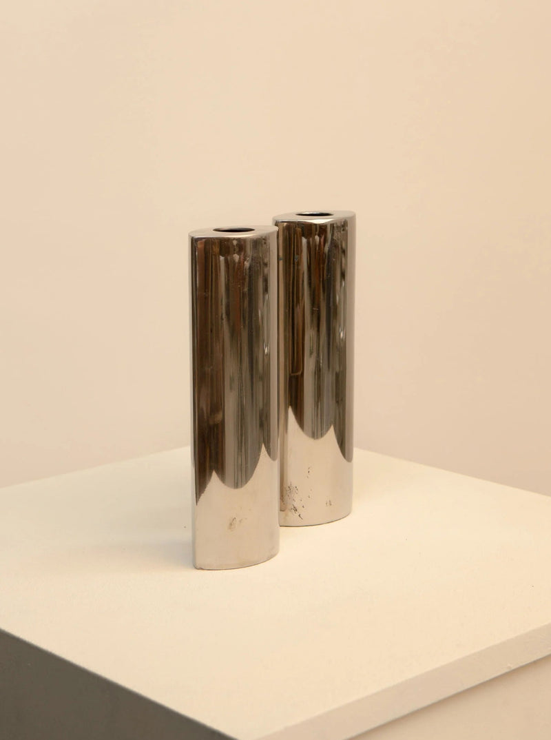 Vintage pair of 80's style metal vases in teal and gold colors, with geometric patterns and sleek design 