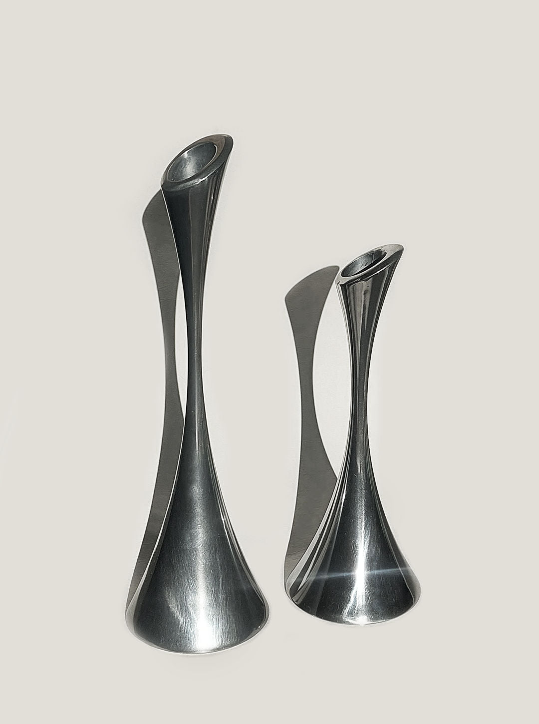 A pair of elegant silver candle holders standing on a table