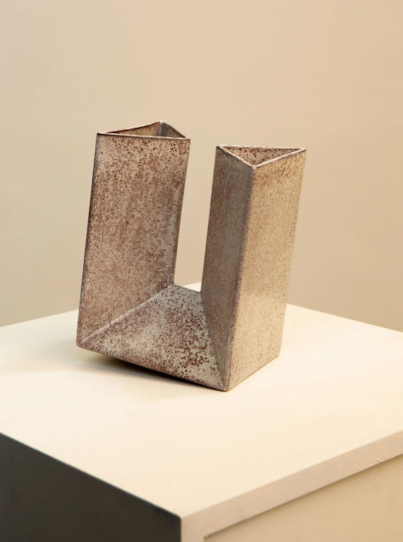 A Ceramic Vase by Alessio Tasca 70's with a unique, asymmetrical, and angular design, displayed on a neutral-toned background. This Italian ceramic vase has a textured, speckled brown finish reminiscent of the 1970s by Treaptyque.