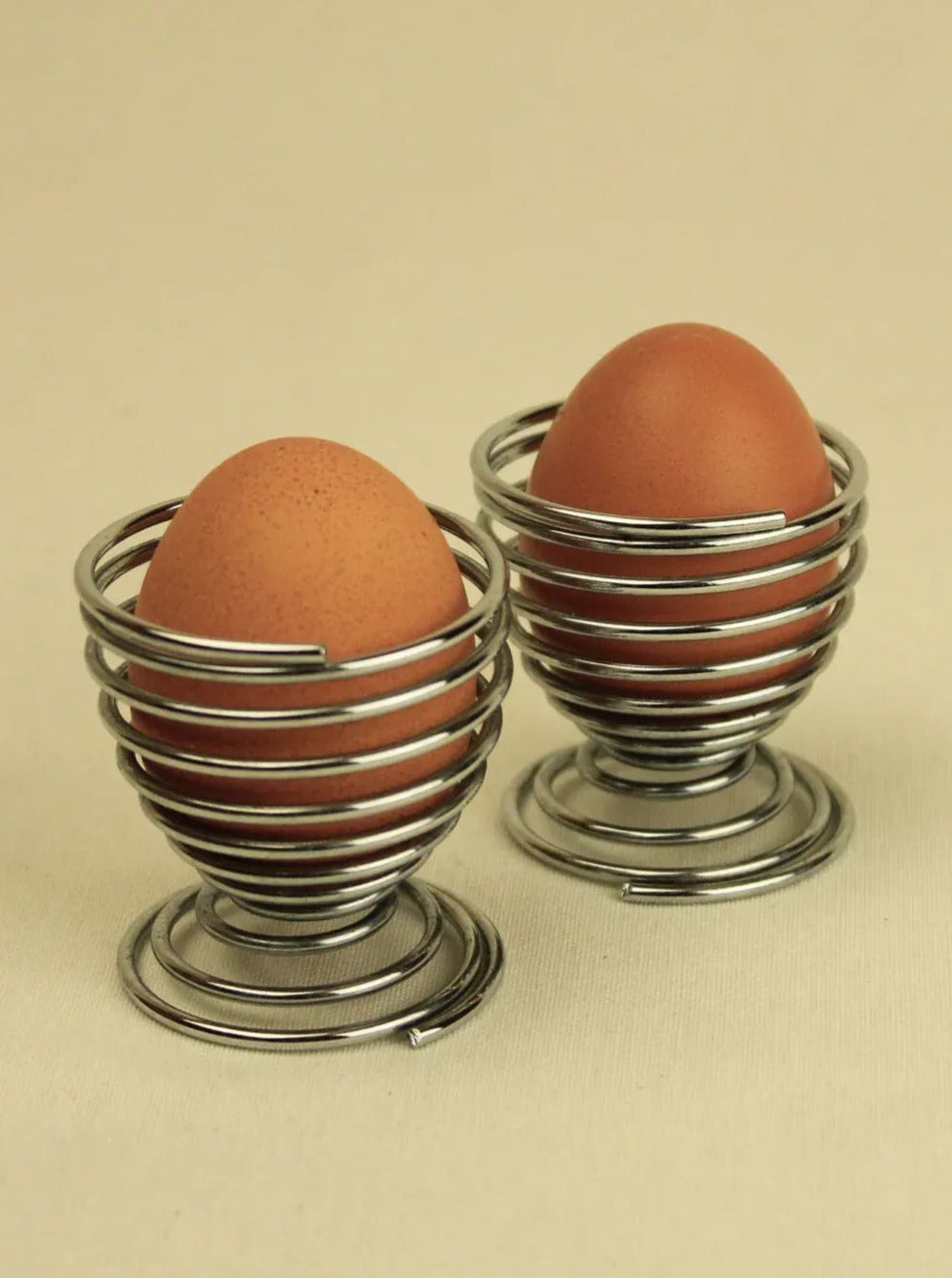 Set of 4 ceramic swirl pattern egg cups in assorted colors