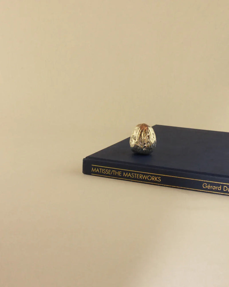Silver Walnut Sculpture crafted from polished metal, resembling a majestic tree