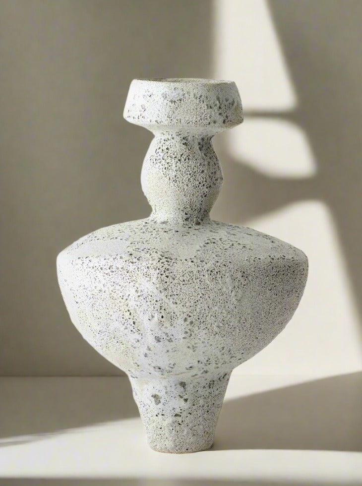 Abstract ceramic Lydion Vase by Canoa Lab with a speckled, sandstone-like texture featuring a stacked design, resembling interconnected forms with a flat-topped upper section on a white background.