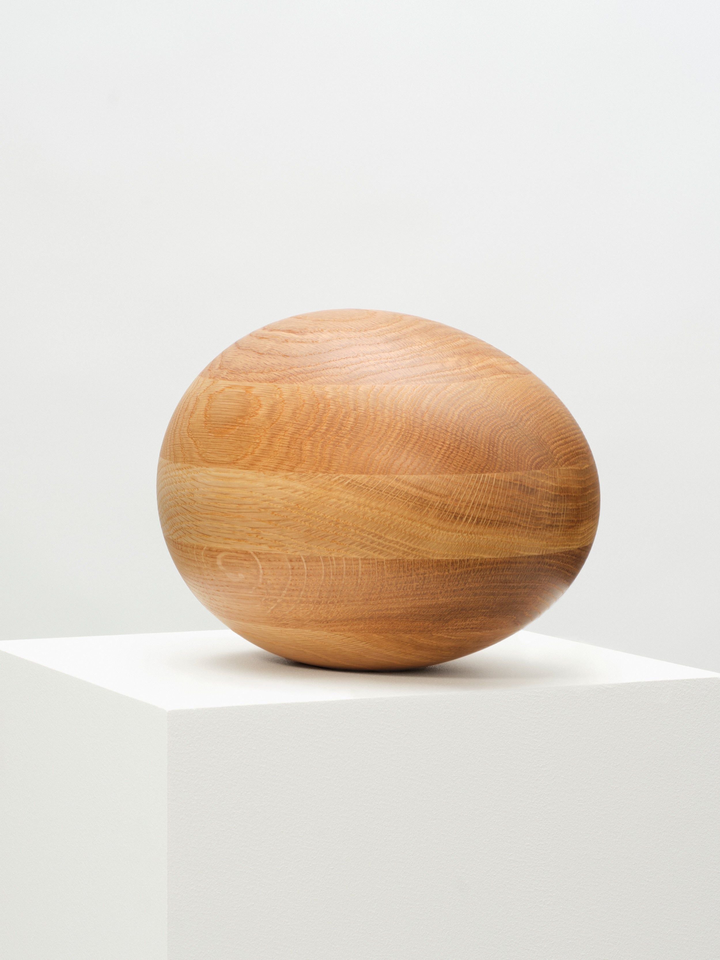Close-up of the Natural Oak Egg Sculpture showing the wood grain and texture