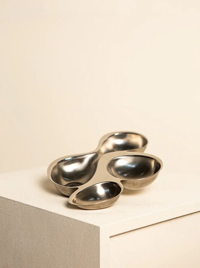 Modern and sleek stainless steel vide poche by renowned designer Ron Arad