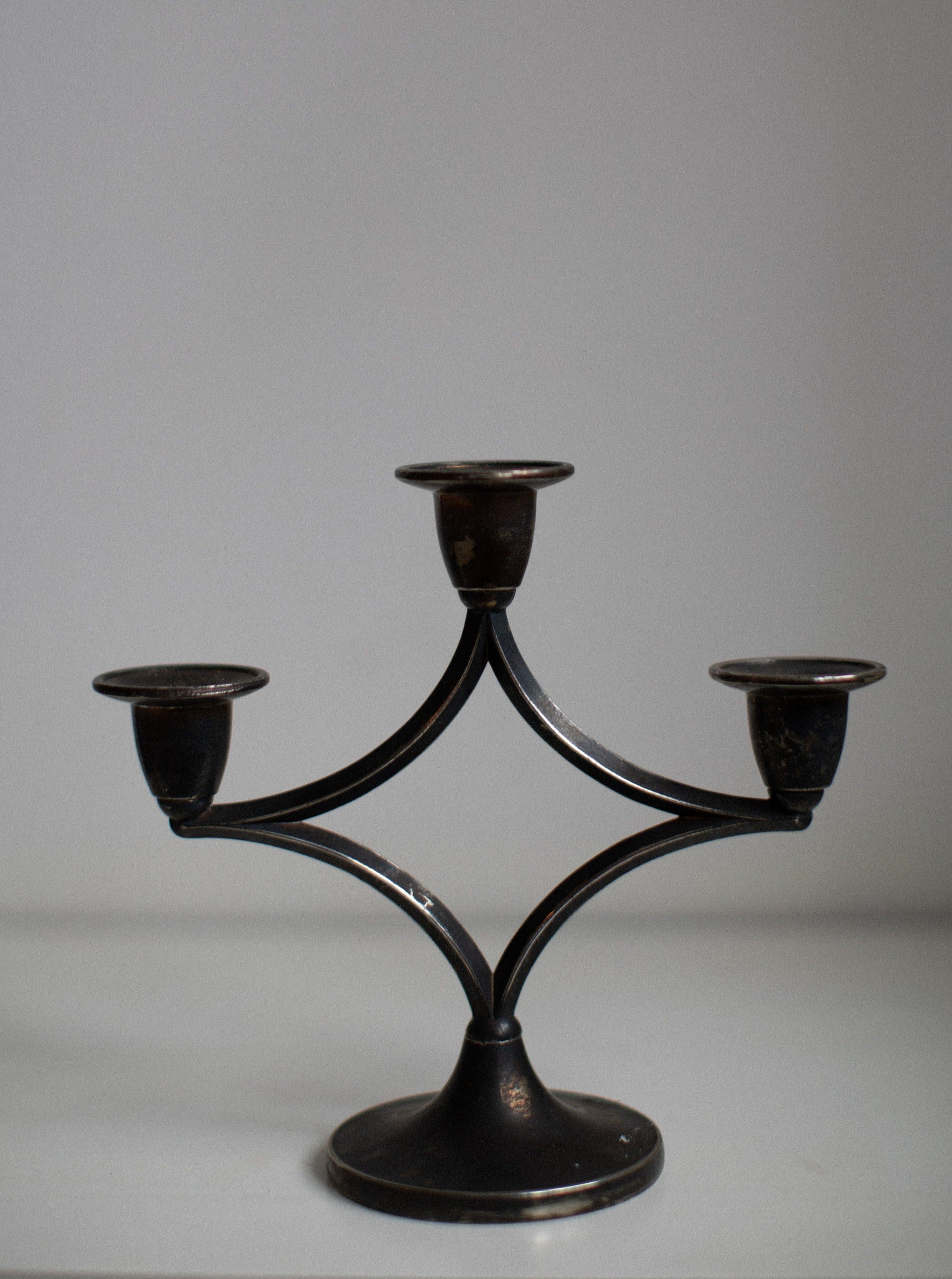 Beautiful dark silverplated candleholder with intricate floral design and smooth finish