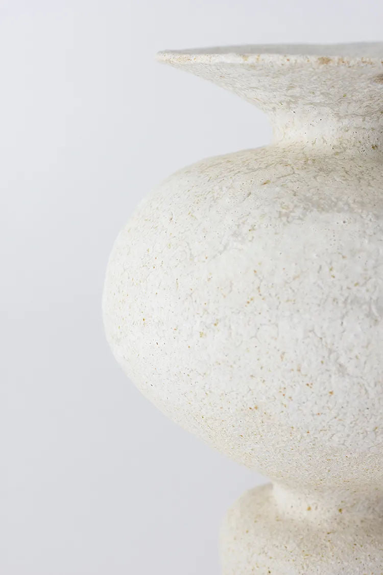 Close-up of a textured, speckled white Canoa Lab Isolated n.11 Vase with a smooth rim against a plain light background, focusing on the curvature and surface detail.