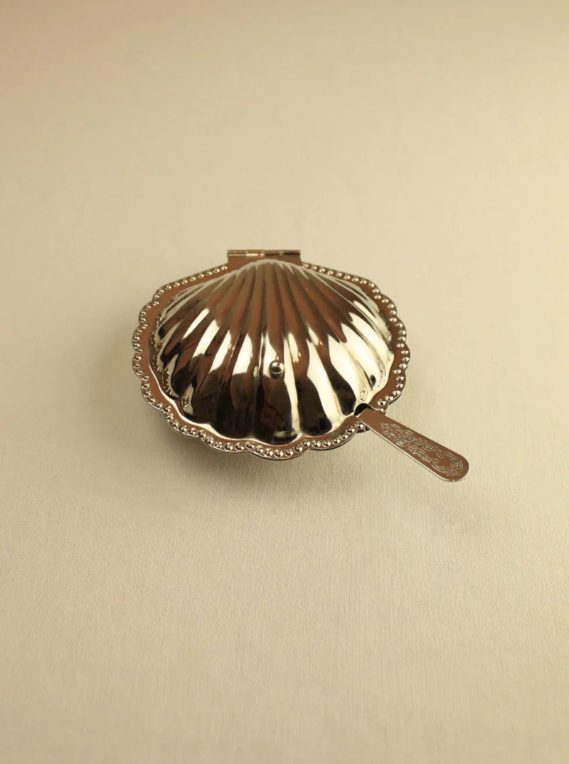 White ceramic shell-shaped butter dish with lid and scalloped edges