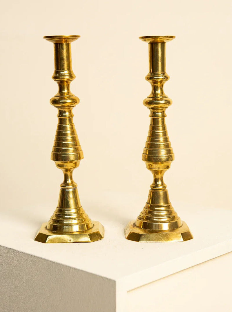 Vintage brass candlesticks with a sleek 60's design, perfect for adding retro charm to any home decor