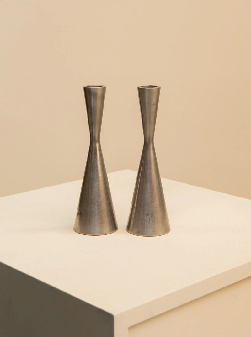 Two vintage Pair of Candlesticks by Erika Pekkari for Ikea 90's with a slim, elegant design, positioned on a white surface against a soft beige background.